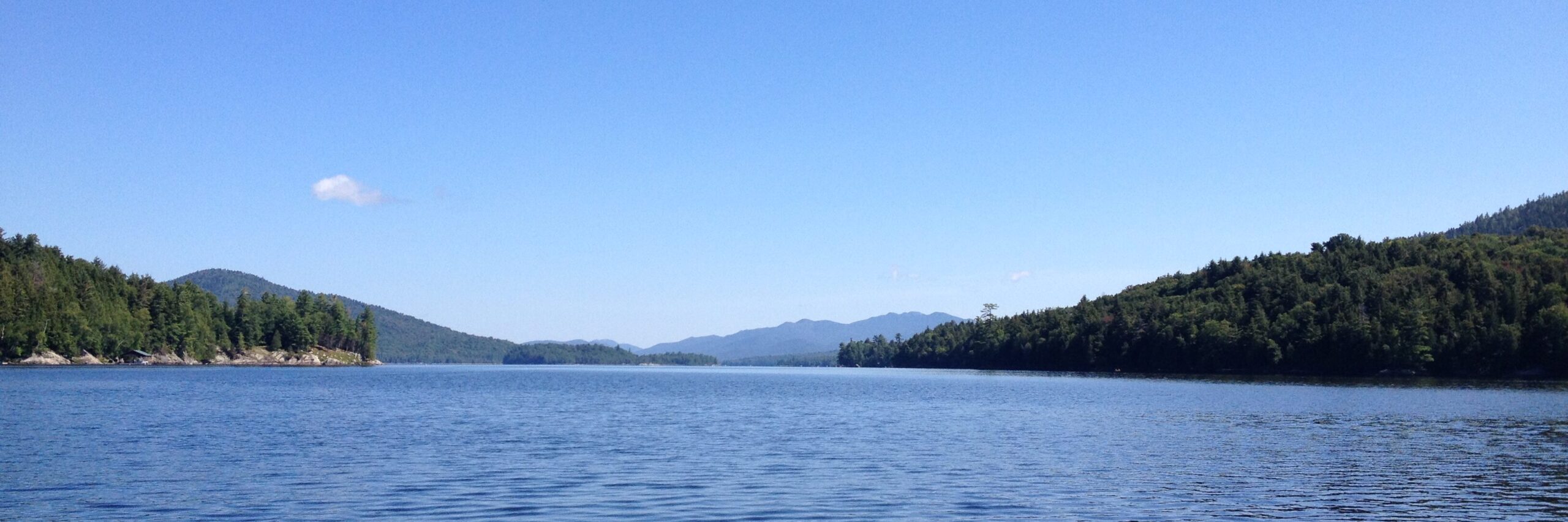Blue lake nestled between green mountains.