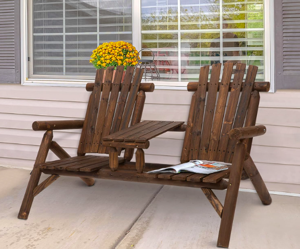 Double Adirondack chair with table on a patio.