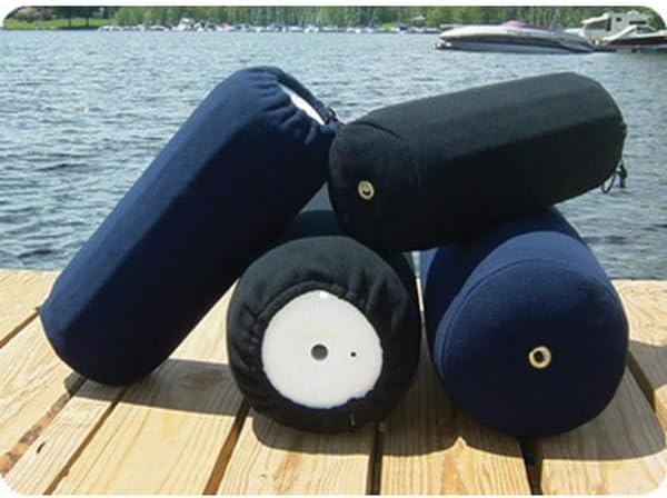 Four boat fenders with covers sitting on a dock.