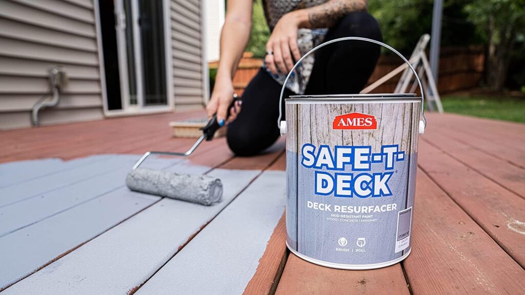 Gray Safe T Deck paint being rolled onto an old deck