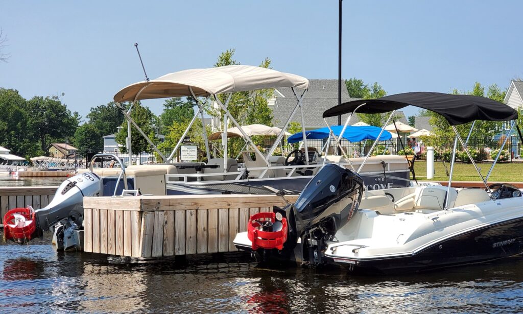 a pontoon boat and a bowrider boat with a boat motor safety guard installed